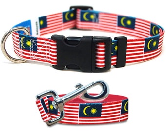 May include: A red, white, and blue dog collar and leash with the Malaysian flag printed on them. The collar has a black plastic buckle and a silver D-ring. The leash has a silver clip.