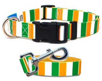 May include: A green, orange, and white striped dog collar and leash set. The collar has a black plastic buckle and a silver D-ring. The leash has a silver clip.