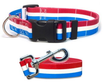 May include: Red, white, and blue striped dog collar and leash set with a black buckle and silver clip. The collar has the text "Made in USA" and "Unique Pet Designs" printed on it.