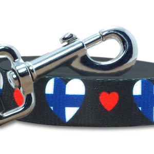 May include: Black dog leash with red and blue hearts featuring the Finnish flag.