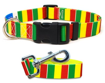May include: A red, yellow, and green striped dog collar and leash set. The collar has a black plastic buckle and a silver D-ring. The leash has a silver clip.
