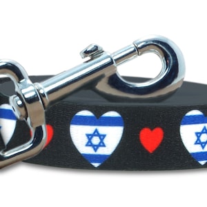 May include: Black dog leash with red hearts and blue and white hearts featuring the Israeli flag.