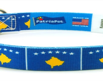May include: A blue and yellow dog collar with the flag of Kosovo printed on it. The collar has a black buckle and a silver D-ring. The collar is made in the USA by PatriaPet.