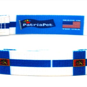 May include: A white dog collar with a blue and white Finnish flag design. The collar has a black plastic buckle and a silver D-ring. The collar is made by PatriaPet.