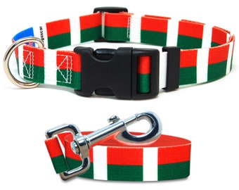 May include: A red, white, and green striped dog collar and leash set. The collar has a black plastic buckle and a silver D-ring. The leash has a silver clip.