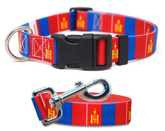 May include: A blue, red, and gold dog collar and leash set with the flag of Mongolia printed on it. The collar has a black plastic buckle and a silver D-ring. The leash has a silver clip.