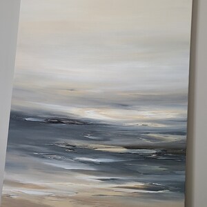 May include: Abstract painting of a seascape with a light blue and gray sky, a dark blue ocean, and a sandy beach.