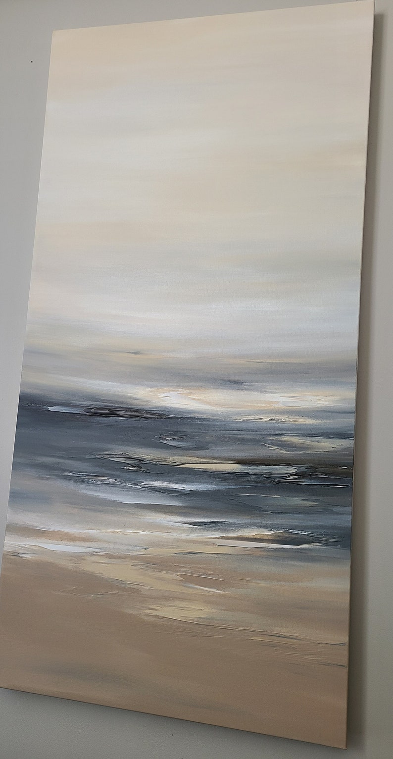 May include: Abstract painting of a seascape with a light blue and gray sky, a dark blue ocean, and a sandy beach.