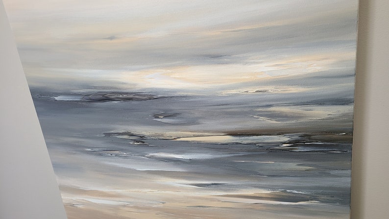 May include: Abstract painting with a seascape theme. The painting features shades of gray, white, and beige, creating a calming and serene atmosphere.