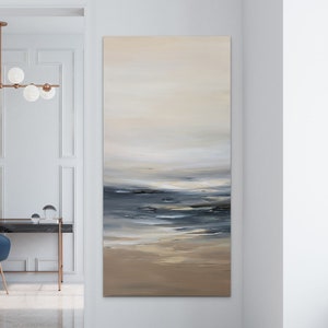 May include: Abstract painting of a seascape with a light blue, gray, and white color scheme. The painting depicts a calm ocean with a sandy beach in the foreground.