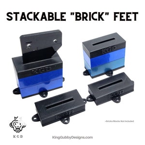 May include: Stackable "Brick" Feet for building blocks. The feet are black and have a slot for the bricks to fit into. The feet are stackable, so you can create different heights. The feet are made by KingGubbyDesigns.com. "Bricks/Blocks Not Included"