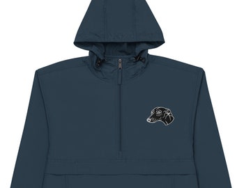 May include: A navy blue Champion windbreaker jacket with a hood and a half-zip closure. The jacket features a black and white embroidered dog head on the chest. The Champion logo is visible on the left sleeve.