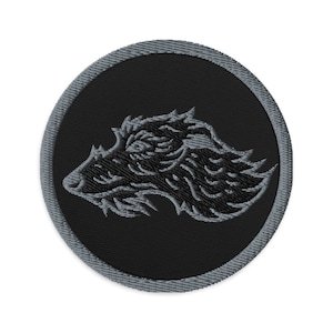 May include: A circular embroidered patch featuring a detailed gray boar head on a black background. The patch has a gray border and is likely designed for application on clothing or accessories.