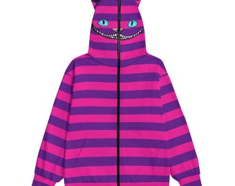 May include: A purple and pink striped zip-up hoodie with a cat face on the hood. The cat face has a wide grin and blue eyes.