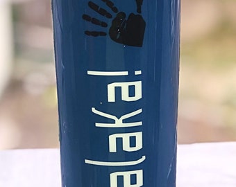May include: A blue stainless steel tumbler with a black handprint and the text "Na'Mlaka'i" in white.