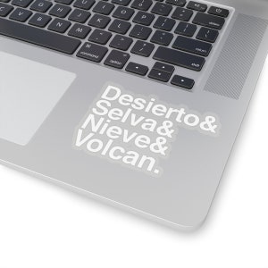 May include: White vinyl sticker with the text "Desierto& Selva& Nieve& Volcan." on a silver laptop.
