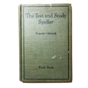 May include: A vintage book titled "The Test and Study Speller" by Starch-Mirick. The cover is a muted green with black text and a black border. The words "First Book" are printed at the bottom.