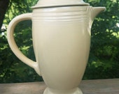 Vintage Homer Laughlin Fiesta Ivory Coffeepot. This fiestaware coffee server with the old original hlc mark does have a chip on the lid.