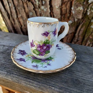 Vintage Demitasse Cup and Saucer by R M Gould Co. With purple Violets and gold accents. Made in California in 1950s