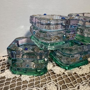 May include: A set of three ceramic canisters with lids, featuring a blue and white floral pattern. The canisters vary in size, with the largest measuring approximately 8 inches in height. They are likely used for kitchen storage.