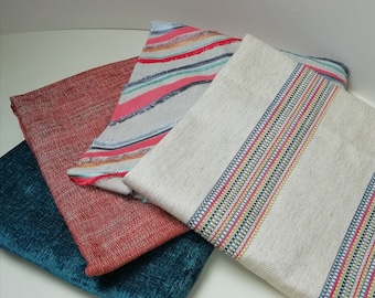 Bundle of woven, appliquéd and chenille fabrics in lovely warm colours.