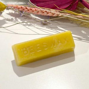 May include: A yellow beeswax block with the word "BEESWAX" embossed on the top.