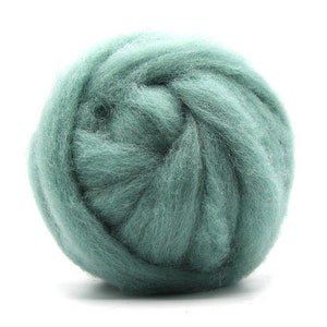 May include: A ball of teal blue wool roving. The wool is soft and fluffy, perfect for felting or spinning.