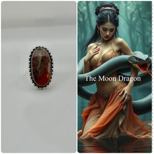 May include: Oval-shaped ring with a large, reddish-brown stone set in a silver-colored metal. The stone has a marbled appearance. The ring is on a white background. The text "The Moon Dragon" is visible in the image.