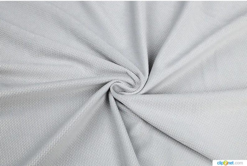 May include: Close-up of a light gray fabric with a woven texture. The fabric is swirled in a spiral pattern, creating folds and shadows. The material appears soft and pliable, suitable for clothing or home decor.
