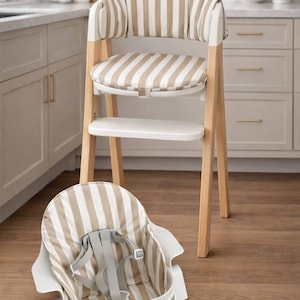 May include: A modern high chair with a removable seat. The chair features a light wood frame, white accents, and a seat cushion with beige and white vertical stripes. A matching seat is on the floor. The high chair is designed for infants and toddlers.