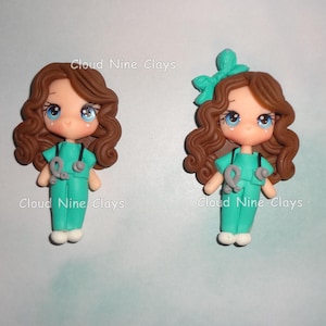 May include: Two clay figurines of nurses with brown wavy hair, blue eyes, and teal scrubs, each wearing a gray stethoscope. The text Cloud Nine Clays is visible near each figure. The figure on the right features a teal bow in the hair.