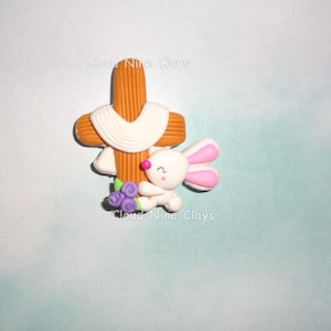 May include: A set of three ceramic mugs with a speckled, matte finish. The mugs are in shades of cream, light gray, and dark gray. Each mug has a simple, minimalist design and a rounded handle.