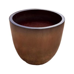 May include: A round, deep planter with a smooth, tapered silhouette. The exterior features a gradient finish, transitioning from a dark, near-black rim down into a warm, earthy brown base. The interior is dark, showing a deep, hollow basin.