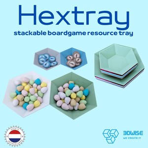 May include: Hexagonal stackable board game resource trays in various colours, filled with game pieces. The trays are in white, grey, blue, and green. The image includes the text "Hextray" and "stackable boardgame resource tray."
