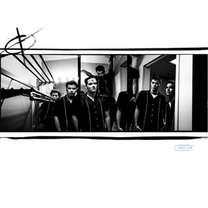May include: Black and white photograph of a group of men in matching black shirts with white stripes, standing in a doorway. The image has a vintage aesthetic, with a graphic border and the text "A Wisdom Core" in the bottom right corner.
