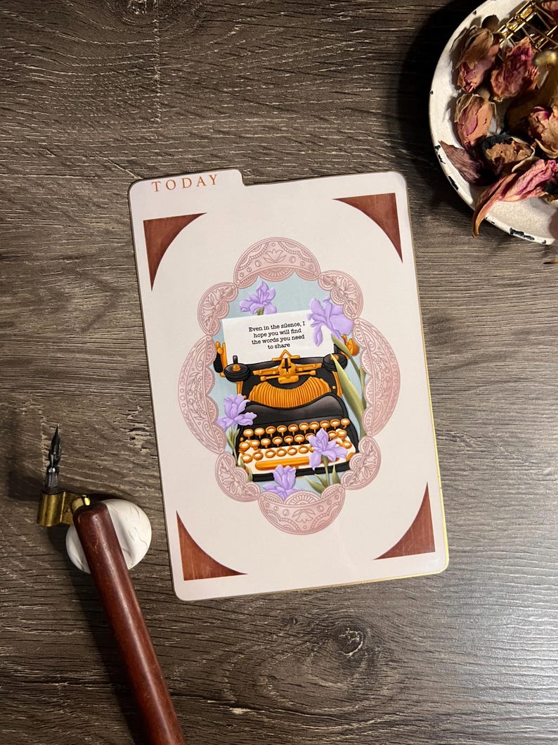 May include: A decorative card with a vintage typewriter illustration, surrounded by a floral design and the text "Even in the silence, I hope you will find the words you need to share." The card has a brown border and the word "TODAY" at the top.