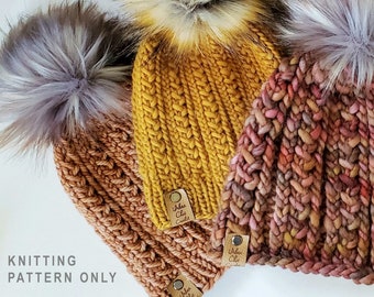 May include: Three knitted hats with pom poms in shades of brown, yellow, and pink. The hats have a textured knit pattern and are adorned with small leather tags that read "Urban Chic Crafts".