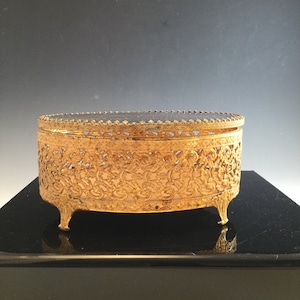 Vintage filigree jewelry box with glass lid
