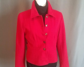May include: A red blazer with a button-up front and long sleeves. The blazer is fitted and has a cropped length.