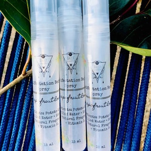 May include: Three clear plastic bottles with a white label and black text. The label has a triangle with a circle inside. The text on the label reads "Daily Manifestation Body Spray" and "Grapefruit Love". The bottles are 15 ml each.