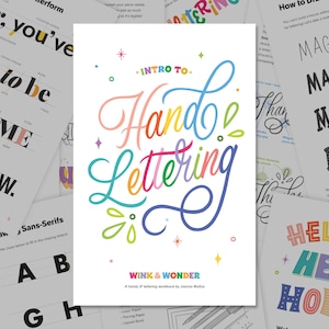 May include: A workbook titled "Intro to Hand Lettering" with colorful script lettering. The cover features the title in a rainbow of colors, with the words "Wink & Wonder" and the author's name at the bottom. Other pages with lettering examples are in the background.
