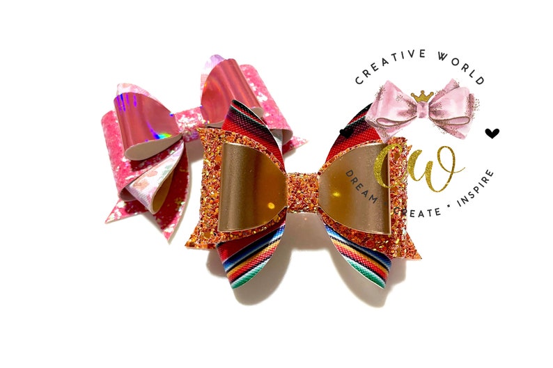 May include: Two hair bows, one with a red, orange, and yellow striped pattern and gold glitter, and the other with a pink and white iridescent pattern. The bow with the striped pattern has a gold mirror in the center. The bows are on a white background.