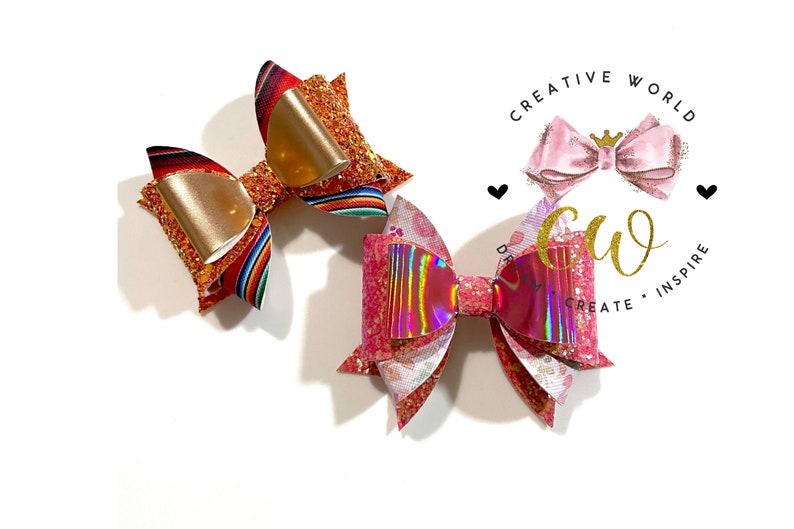 May include: Two handmade hair bows, one with a red, orange, and yellow striped pattern and gold glitter, and the other with a pink and white floral pattern and iridescent glitter.