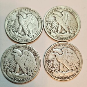 May include: Four silver United States half dollar coins with the image of an eagle on the front. The coins are from the 1900s.