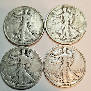 May include: Four silver Walking Liberty half dollar coins from 1942, 1944, 1945, and 1947. Each coin features the image of Liberty walking with a torch and an olive branch, with the inscription "In God We Trust" and the year of minting.