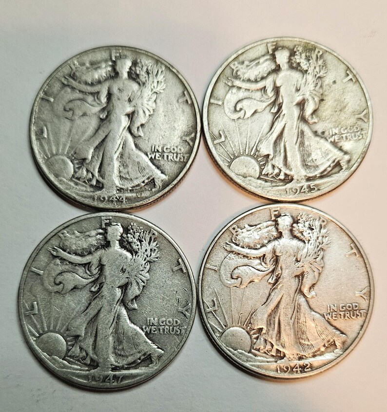 May include: Four silver Walking Liberty half dollar coins from 1942, 1944, 1945, and 1947. The coins feature the image of Liberty walking with a torch and an olive branch.