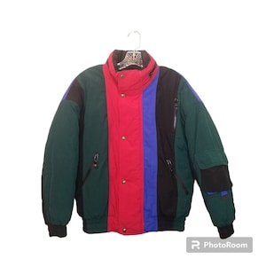 May include: A multi-colored puffer jacket with green, red, blue, and black vertical stripes. The jacket has a zipper closure and multiple pockets.