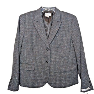 May include: A gray blazer with a subtle multi-colored pattern. The blazer has a two-button closure and two front pockets.