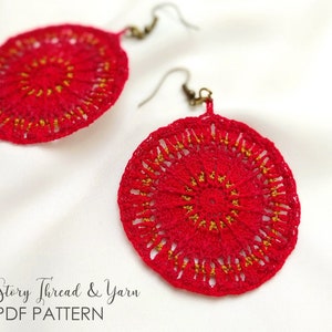 May include: A pair of crocheted earrings with a red and gold mandala design. The earrings are made with a delicate crochet stitch and feature a circular shape. Re-Story Thread & Yarn PDF PATTERN.