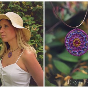 May include: A purple and gold crocheted mandala pendant necklace hanging from a brown leather cord. The necklace is hanging from a branch in a garden setting.